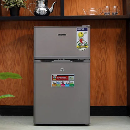 Geepas 84L Double Door Defrost Refrigerator – GRF1259GPE, Rapid Cooling, Tropic Type, CFC-Free, Metallic Grey