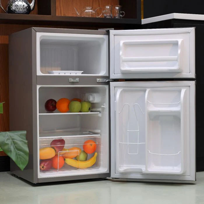 Geepas 84L Double Door Defrost Refrigerator – GRF1259GPE, Rapid Cooling, Tropic Type, CFC-Free, Metallic Grey